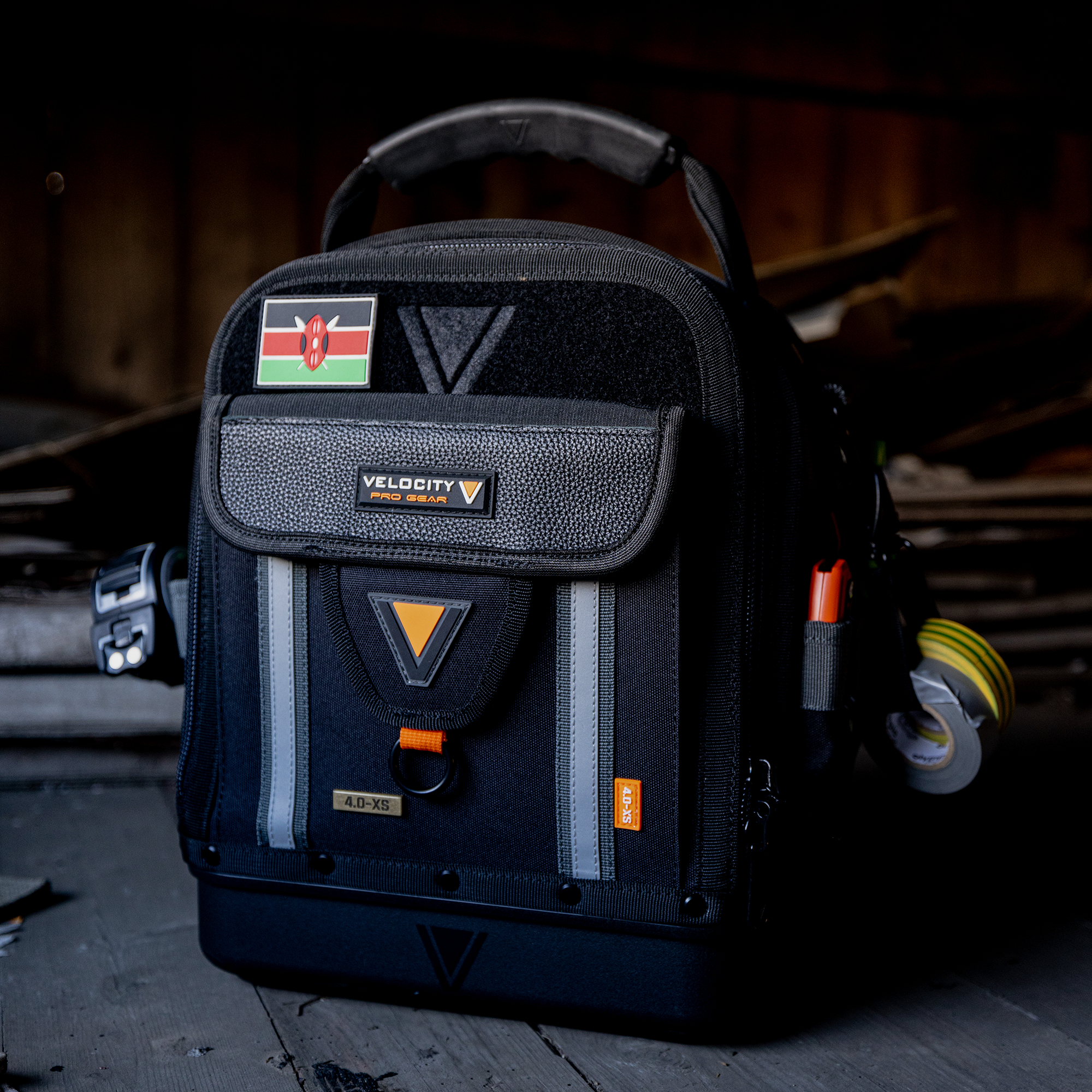 Rogue 4.0XS Tech case with Kenya flag patch and tools on the outside, sitting in a work site